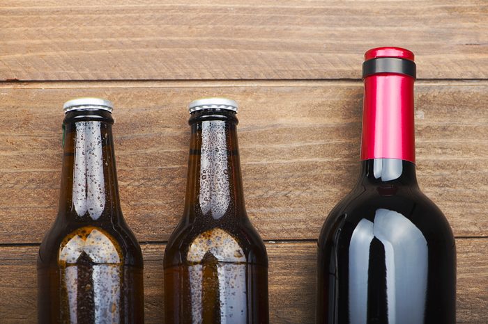 Top view of two beer bottles and a wine on wooden table