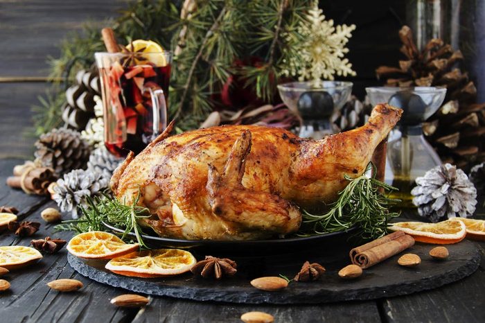 Roast chicken or turkey for Christmas and New Year with mulled wine and Christmas decorations, selective focus