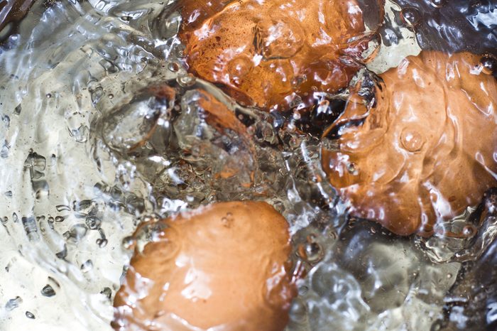 boiling water in a saucepan with boiled chicken eggs