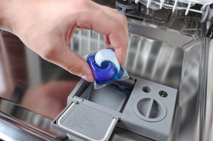 Dishwasher Capsule hand holds the capsule