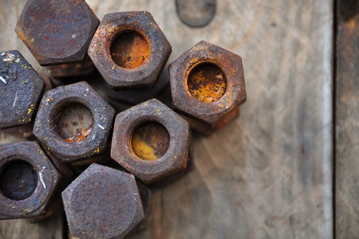 Old bolts or dirty bolts on wooden background, Machine equipment in industry work.