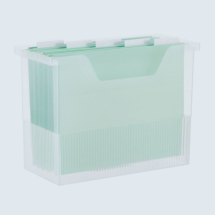 Transparent box holds mint green hanging file folders, standing upright against a plain, light background.