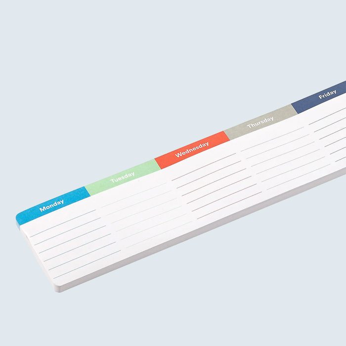 Weekly planner pad displaying days Monday to Friday with lined sections for notes, placed on a plain light background.