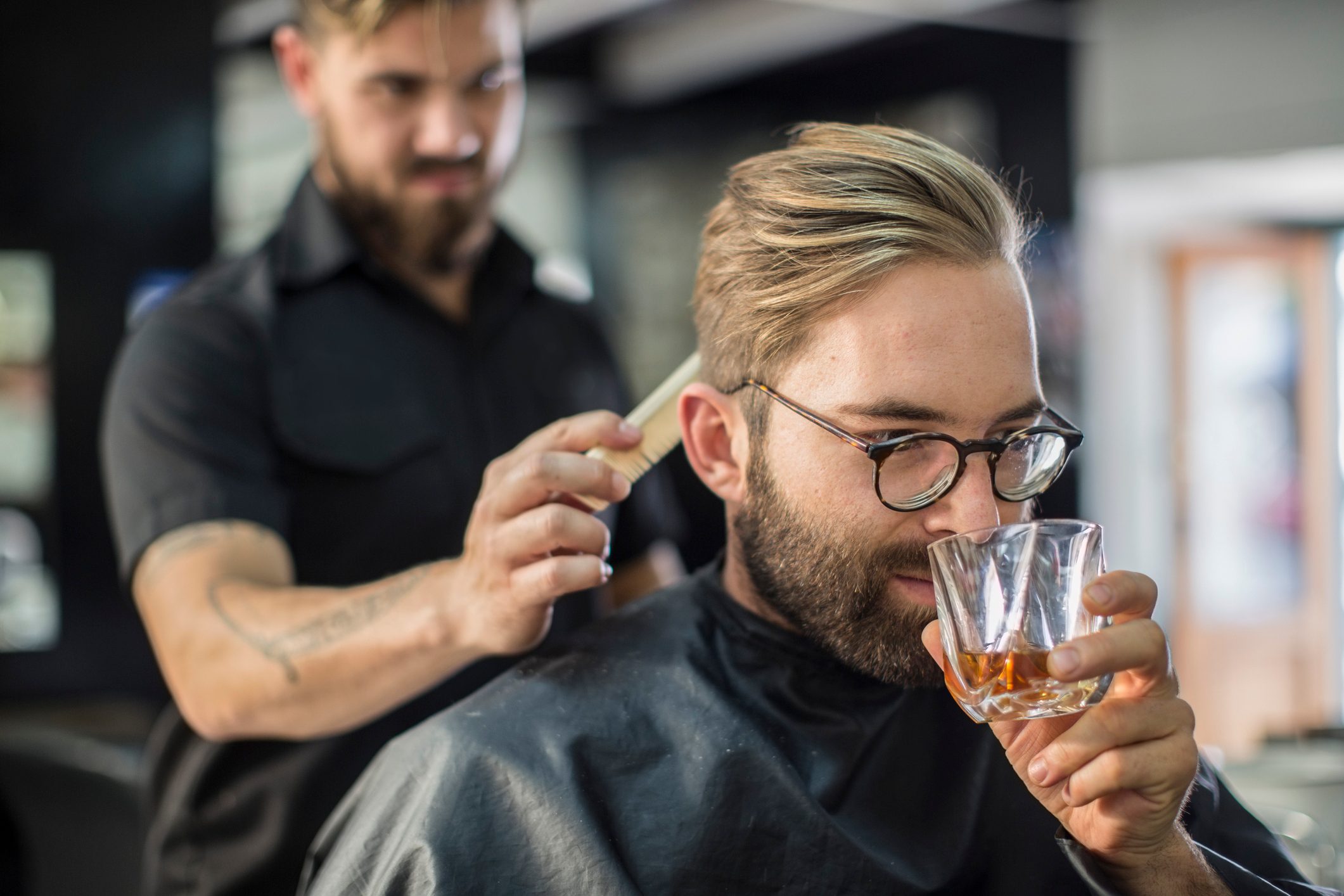 Barber combing hair of a customer