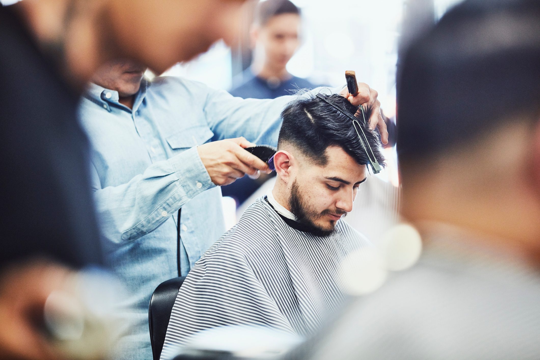 Man having hair cut in barber shop