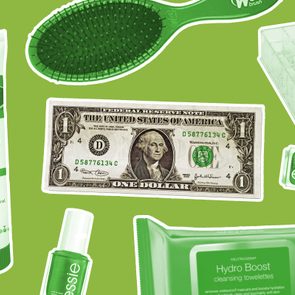 Various green beauty products and a dollar bill are scattered on a green background, including lotion, nail polish, and cleansing towelettes.