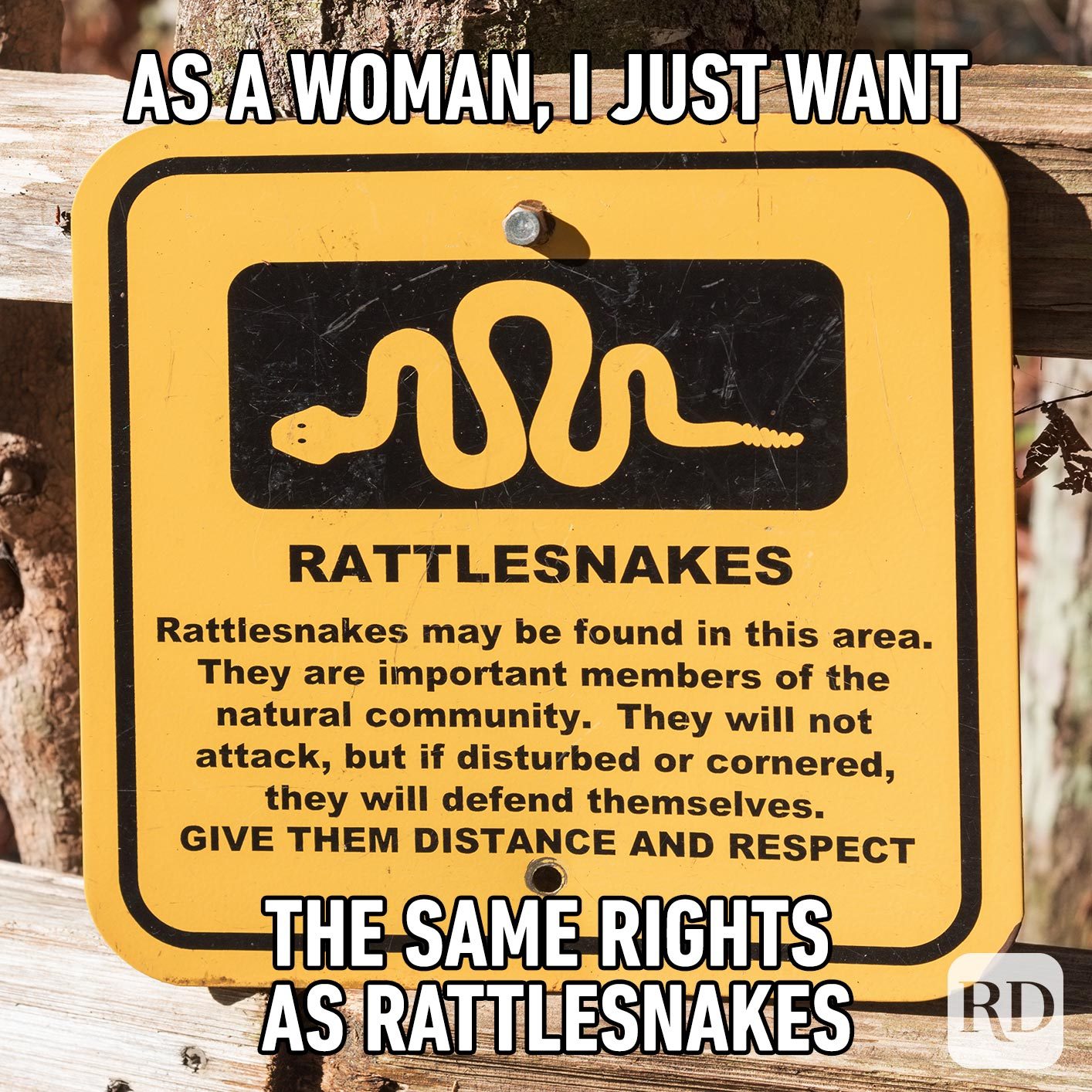 Sign that tells hikers to give rattlesnakes distance and respect. Meme text: As a woman, I just want the same rights as rattlesnakes