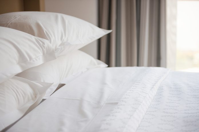 hotel bed with many pillows