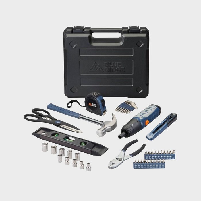 Tools arranged on the floor include scissors, hammer, pliers, screwdrivers, and sockets, with a black plastic case labeled 