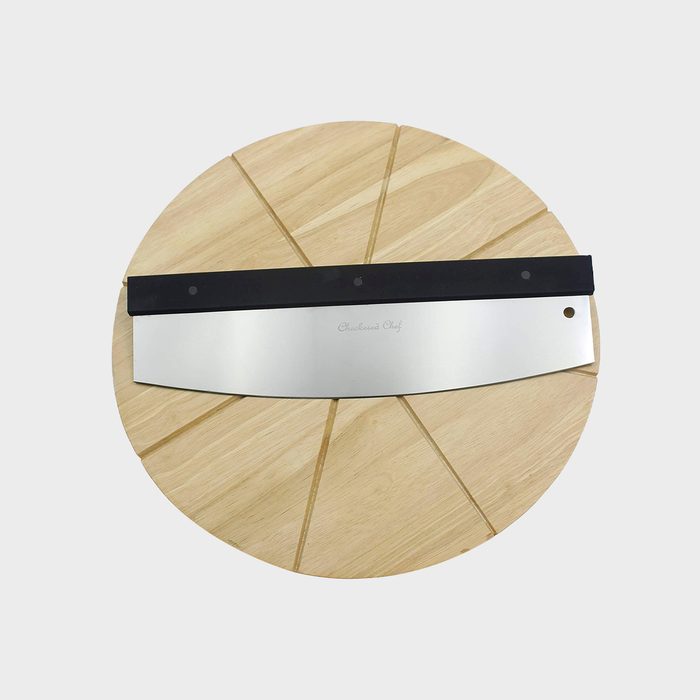 Pizza cutter rests on a segmented wooden board, engraved with 