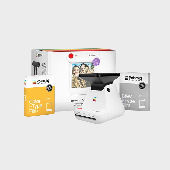Polaroid Lab printer sits between color and black-and-white film boxes against a plain background, with packaging displaying sample photos.