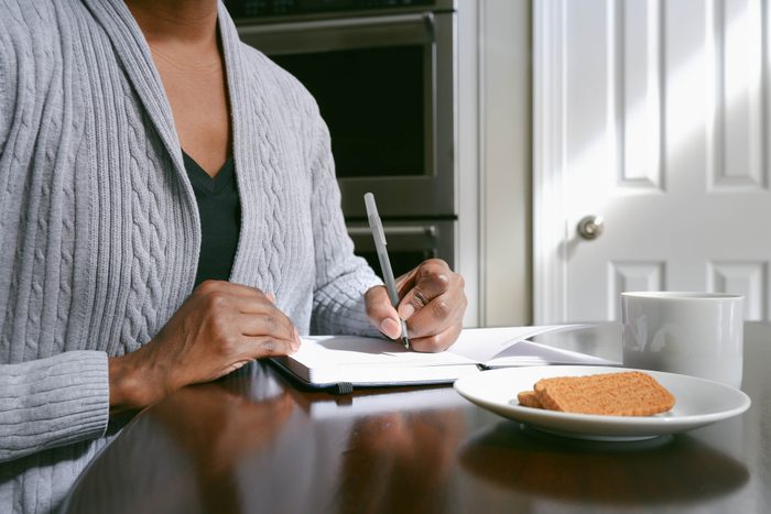 Woman Writes in Journal