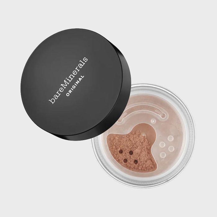 Container holds loose powder, partially opened, with black lid labeled 