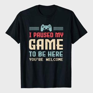 A black T-shirt displays a gaming controller with text: 