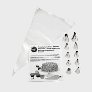 Piping bag with metal tips arranged beside decorating instructions featuring images of cakes and cupcakes in a culinary setting.