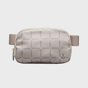A small beige waist bag displays 