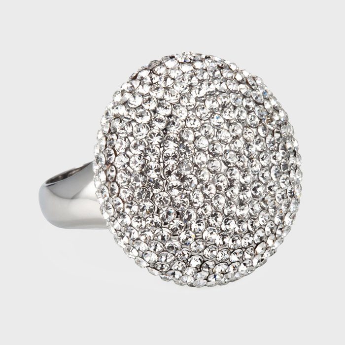 A silver ring displays numerous small, sparkling crystals in a circular pattern, set against a plain white background.