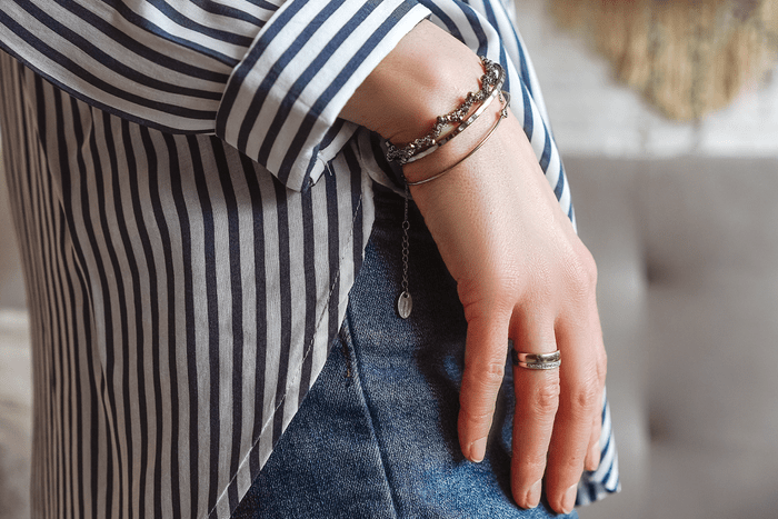 Bracelets and ring on the hand of a young woman close-up, part of body.