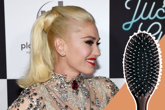 A woman with styled blonde hair smiles, wearing a jeweled dress. A hairbrush overlays the image. Background features black and white text.