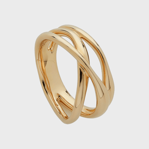 A gold ring intertwines elegantly with overlapping bands against a plain, neutral background.