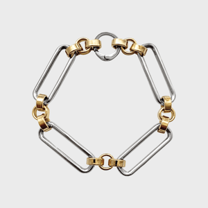 A bracelet with silver rectangular links interspersed with gold circular connectors, arranged neatly on a plain white background.