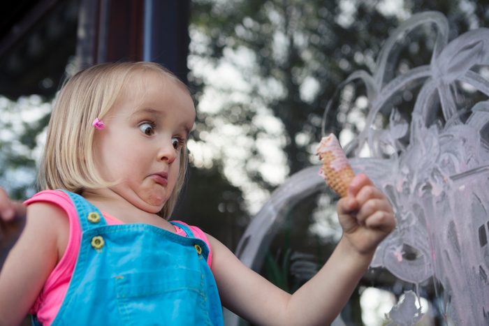 Girl (4-5) caught in the act, making a mess with ice cream