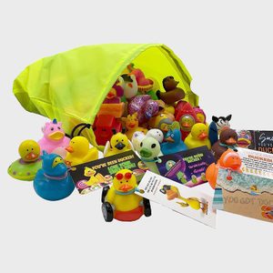 Various rubber ducks spill from a bright yellow bag, surrounded by colorful cards with messages like 