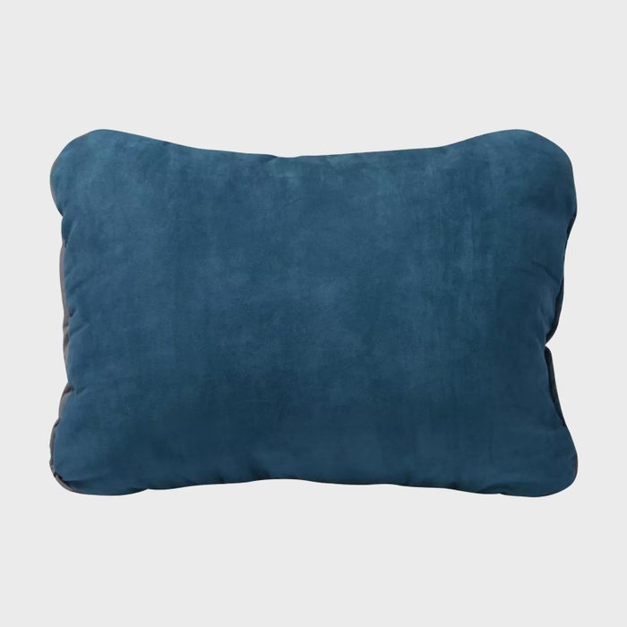 A blue rectangular pillow rests against a plain white background, emphasizing its soft texture and simple design.
