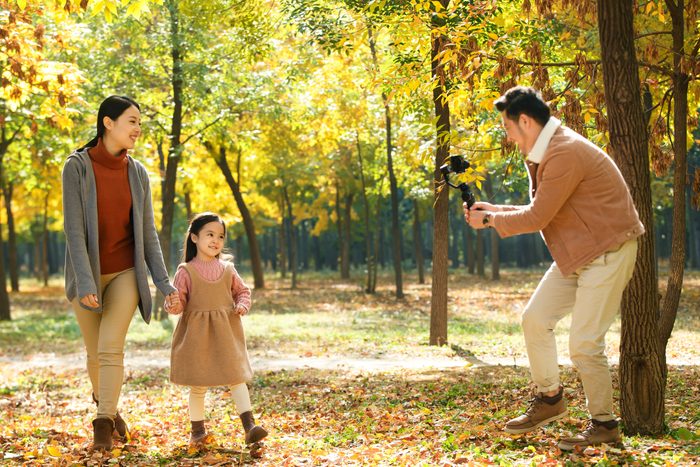 Happy family in the outdoor taking pictures