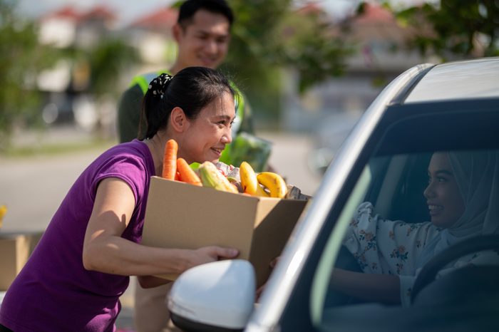Volunteer received donation food at drive through food bank