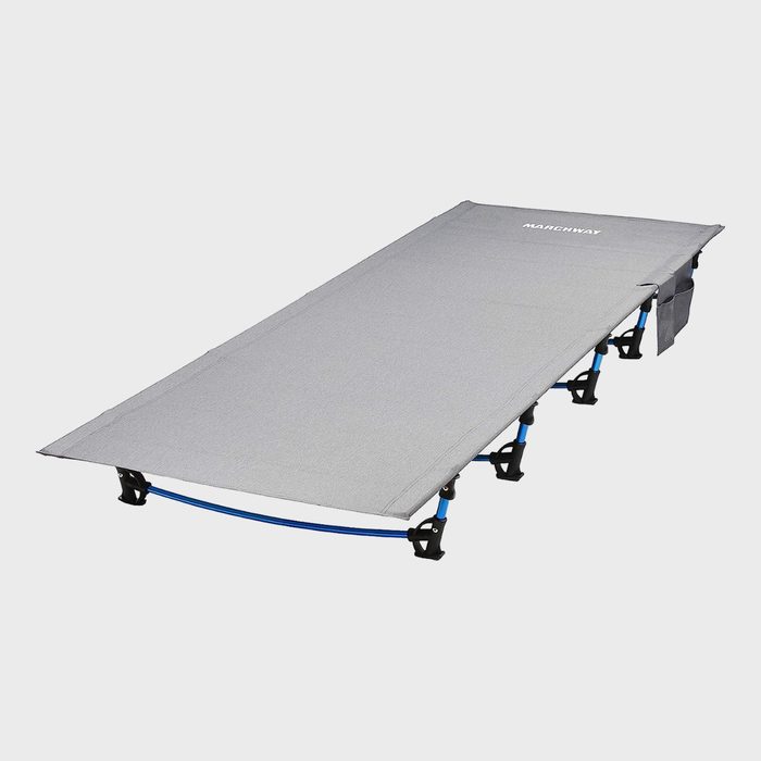 A gray camping cot is set up, featuring blue metal legs, against a plain white background. 