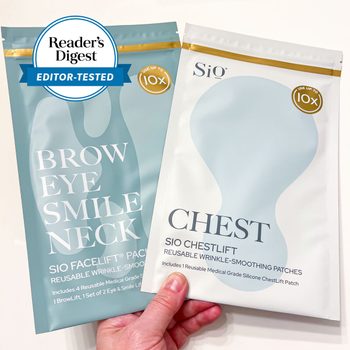 Hand holds two skincare patch packages, featuring bold text about facial and chest wrinkle-smoothing. The Reader's Digest "Editor-Tested" seal is visible.