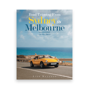 A yellow convertible drives along a coastal road, under blue skies. Text above reads 