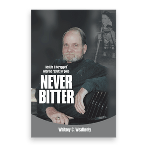 A man seated, wearing a dark sweater, smiles. Text reads, 