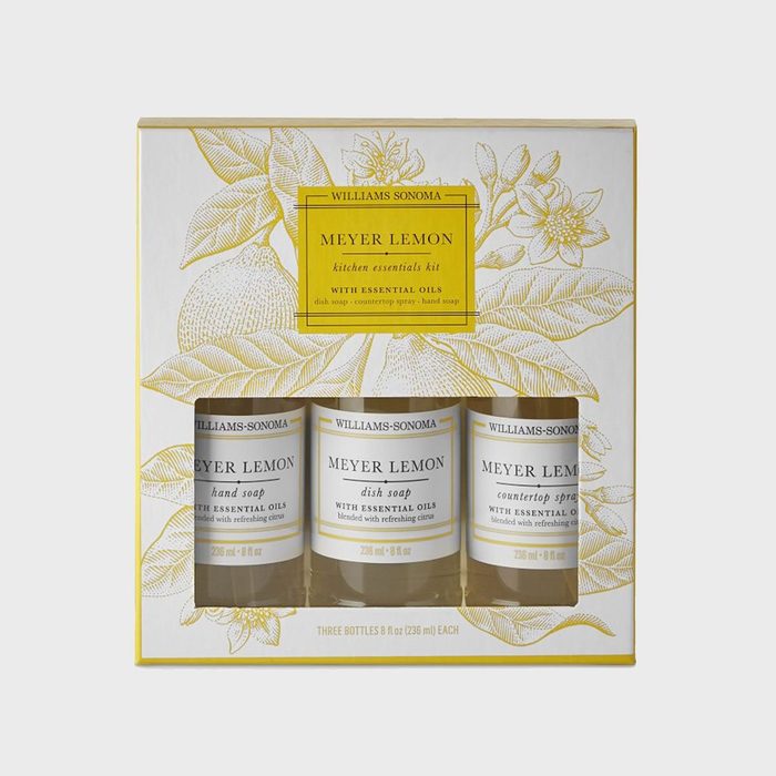 Three bottles containing Meyer Lemon soap and spray sit in a decorative box adorned with lemon illustrations.