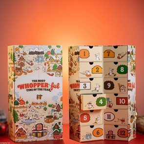 Advent calendar displaying numbered doors, set slightly open in a festive scene. Text reads 