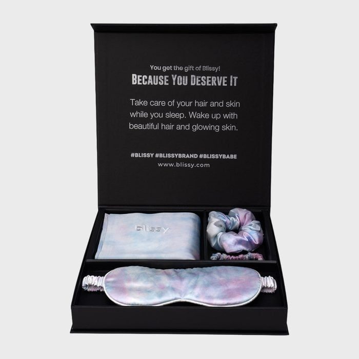 Silk sleep accessories displayed inside an open black gift box with text promoting hair and skin care benefits during sleep.