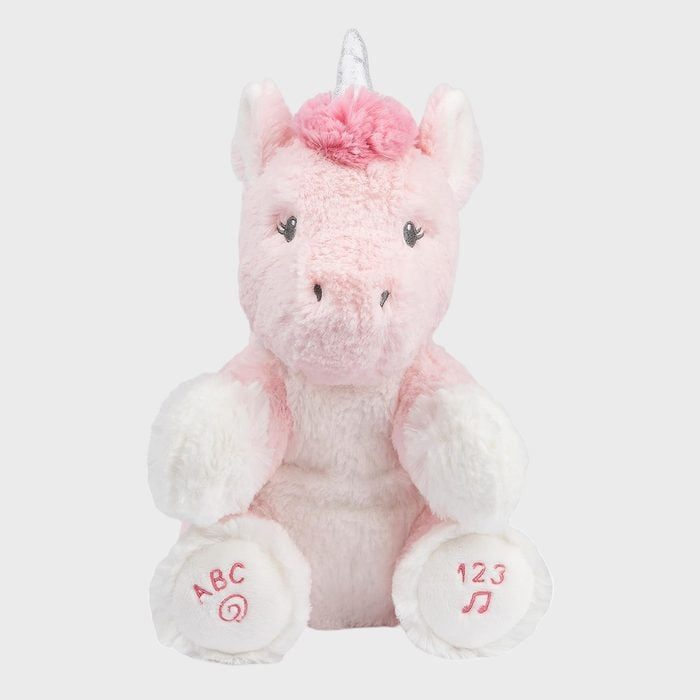 A pink plush unicorn sits upright, embroidered with 