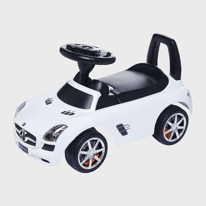 White toy car, styled like a luxury vehicle, is stationary on a plain gray background.
