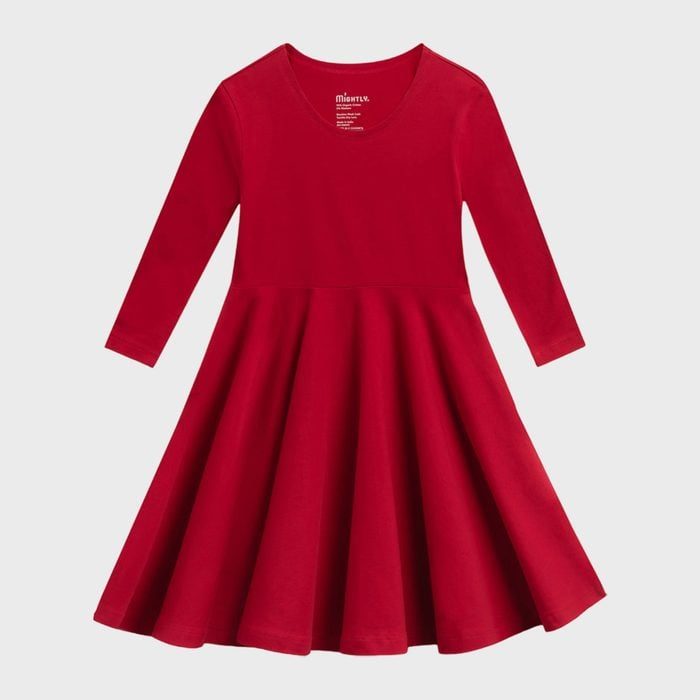 A vibrant red dress with long sleeves hangs against a plain gray background, displaying simple elegance.