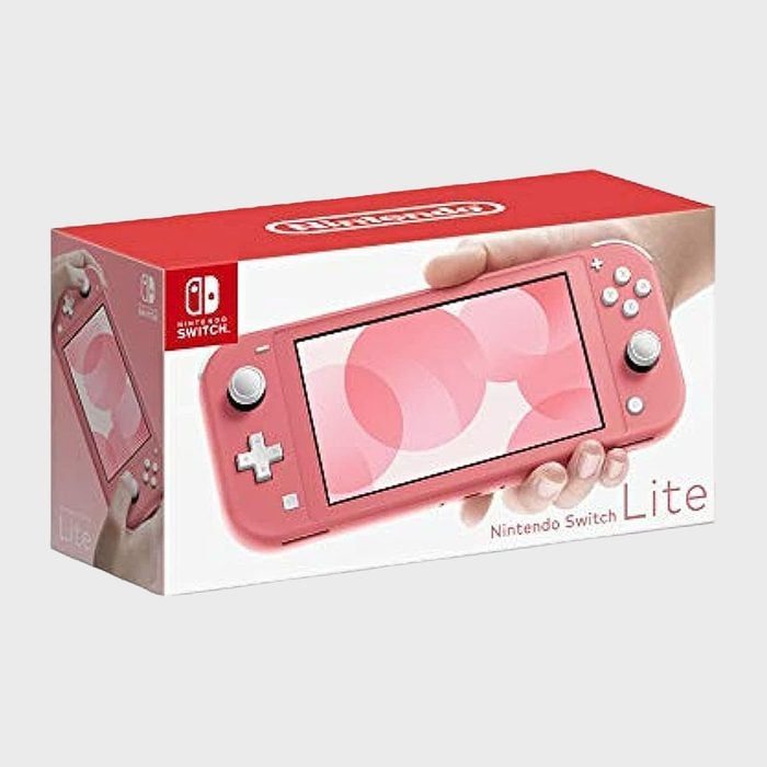 Box shows coral Nintendo Switch Lite held by hands, featuring a geometric design on screen, with branded packaging.