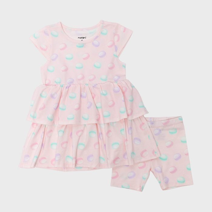 Dress set features pastel polka dots on pink fabric, with a frilled top and matching shorts, displayed on a plain background.