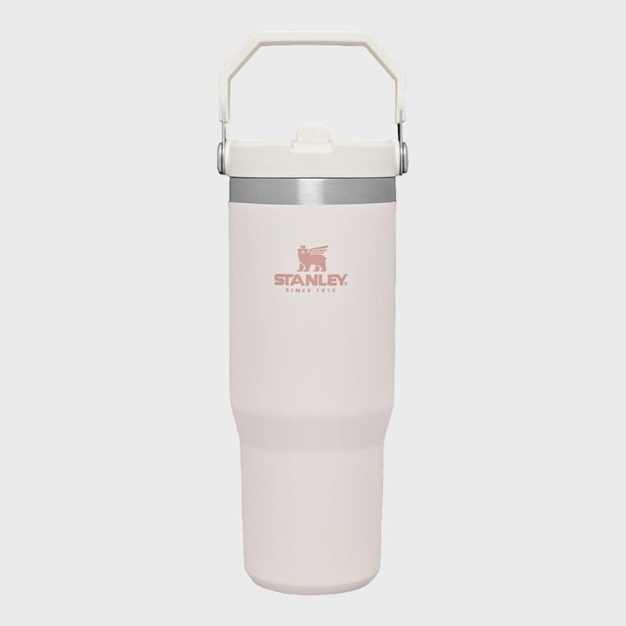 White insulated travel mug, standing upright, features a foldable handle and logo reading 