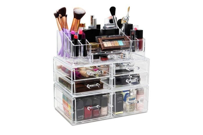 Acrylic makeup organizer holds brushes, lipsticks, and cosmetics, featuring multiple clear drawers and compartments in a neat, compact setup.