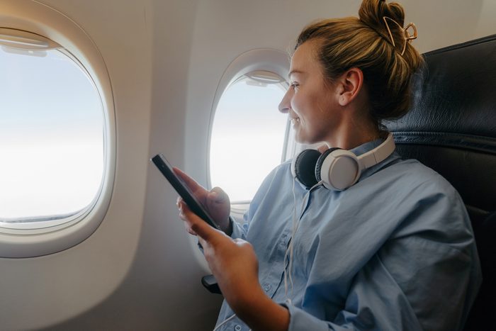 woman with window seat on flight